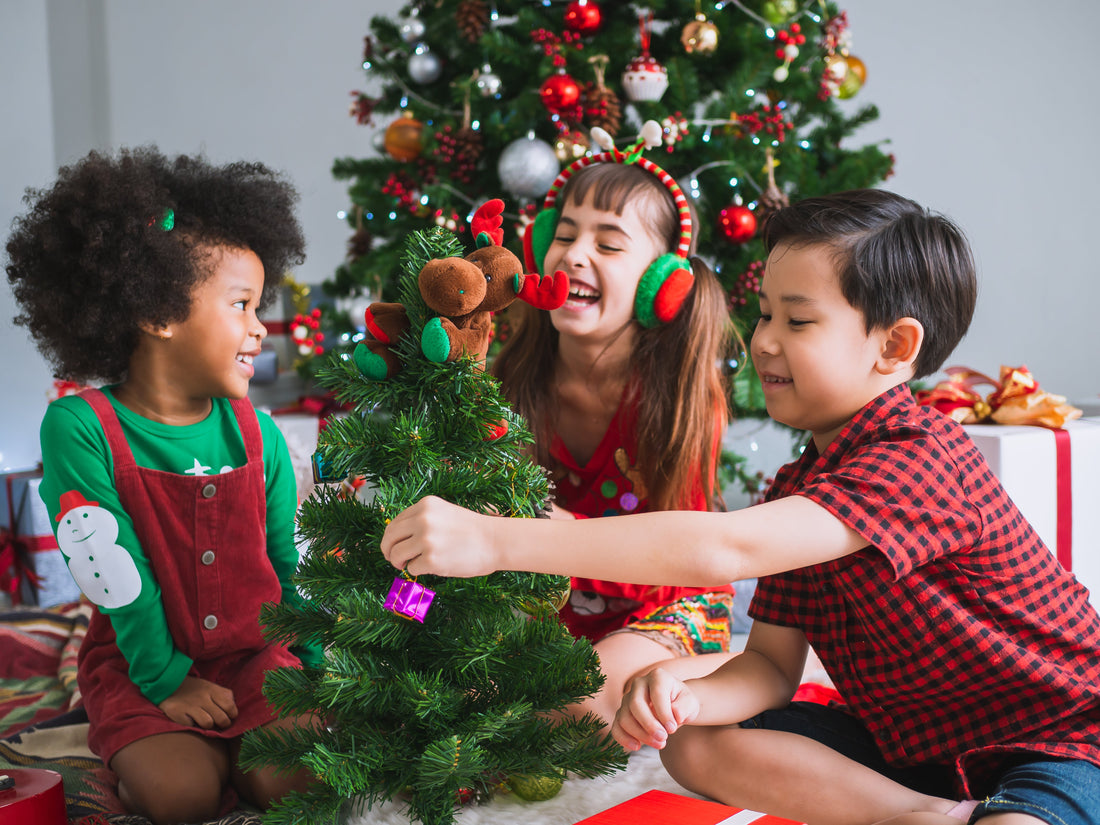 Kids decorating miniature pine tree as a fun Christmas party game